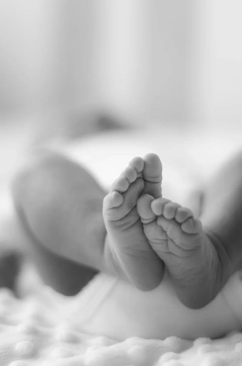 Black and white detail of a newborn's tiny feet